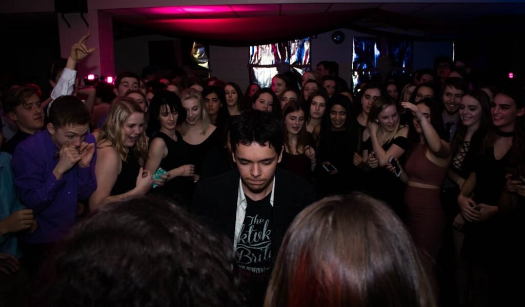 Galería A lively group of young adults dancing and enjoying a nightclub party.